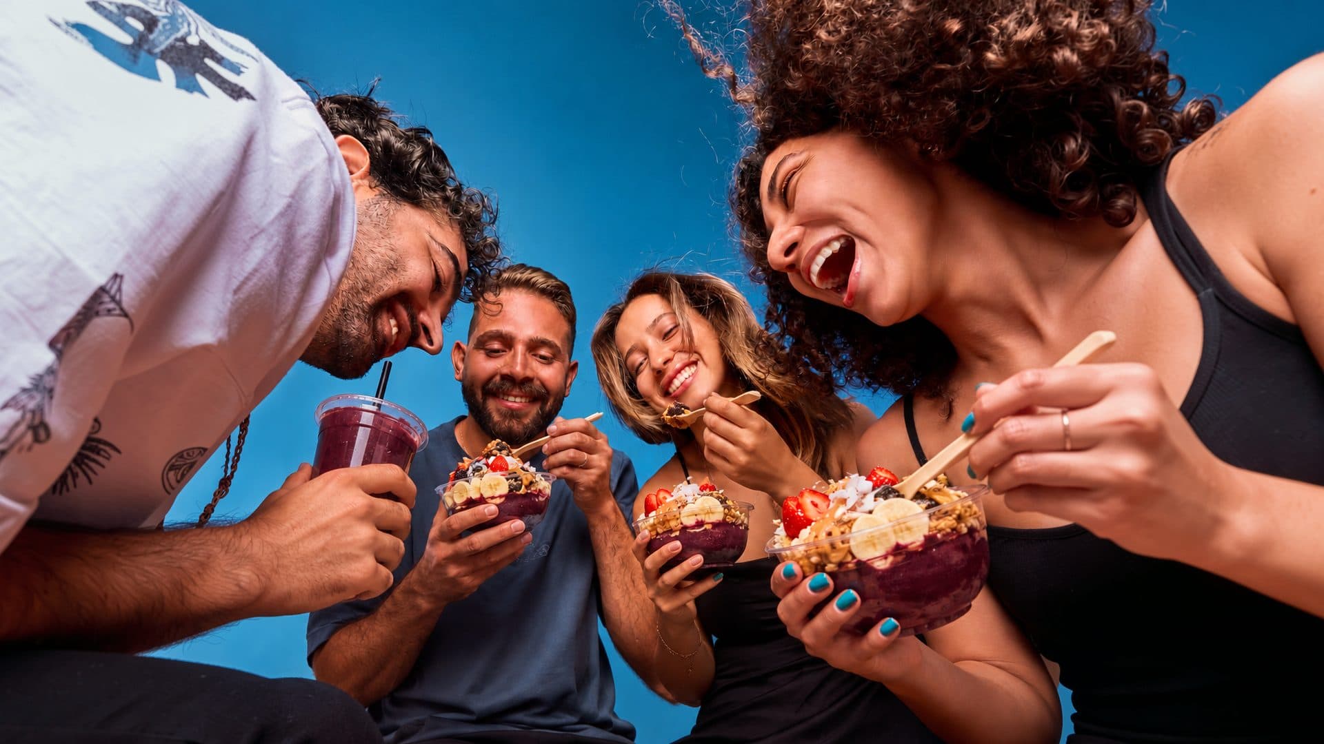 Friends sharing açaí bowls